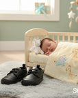 Stork and Baby black faux leather lace-up baby shoes with a classic design, perfect for formal or everyday wear.