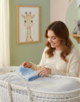 Stork And Baby light blue knitted baby beanie with a pom pom detail, perfect for winter outings.