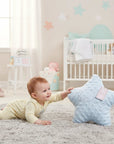 Stork And Baby light blue textured star pillow with "baby" embroidered in script, reaching out to a crawling baby.