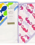 Stork And Baby 100% cotton hooded towel with playful sea creature designs in fish blue and seahorse pink patterns.