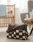 Stork And Baby Diaper Bag in brown with a cute all-over teddy bear print. Features a spacious interior and organized compartments.