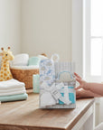 Stork And Baby blue dino hooded towel, washcloths, and wash sponge set. Soft cotton for baby's skin.