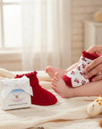 Stork And Baby Girls 2 Pack Socks with red bows and ruffled cuffs. One red sock and one white sock with red bows.