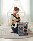 Stork And Baby Mother's Choice grey patterned baby carrier with 3 carrying positions, worn by a mother holding her baby.