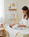 Stork And Baby white infant bathrobe with blue trim, soft and absorbent cotton for baby's comfort after bath.