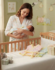 Mother's Choice pastel baby bath robes in pink, yellow, and blue, made from soft, absorbent fabric. Available at Stork and Baby.
