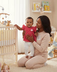 Stork And Baby brand infant girls 2-piece set: fuschia ruffled top with flower detail & white leggings.