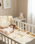 Stork And Baby Mothers Choice Infants Cutwork Blanket in beige and white polyester mink with a house and giraffe pattern.