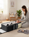 Stork And Baby Mothers Choice 3-in-1 travel bag and portable baby bed with a mother caring for her sleeping infant