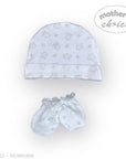 Stork And Baby white cotton newborn hat and mittens set with a subtle house and leaf pattern.