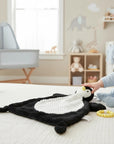 Stork And Baby Mothers Choice Nunu Blanket Penguin, a black and white plush toy with a textured white belly and yellow beak.