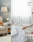 Stork And Baby grey and white quilted cotton baby blanket with rainbow and elephant print