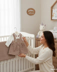 Stork and Baby quilted 2-piece baby dress set in taupe with embroidered collar and button front.
