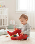 Stork And Baby red tights for infants 0-6 months with floral embroidery and stretchy fit.