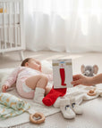 Stork & Baby red tights for infants 0-6 months, soft stretchy fit for all-day wear.