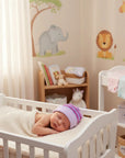 Stork And Baby striped knit baby hat in purple and pink for girls. Cozy winter essential.