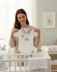 Stork And Baby white 100% combed cotton baby romper with a neutral bunny and balloon print and a grey collar.