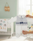 Stork And Baby white long sleeve baby romper with a floral print bodice and blue bow detail