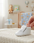 Stork And Baby white leather golfer shoes for baby boys with perforated detail and scalloped trim.