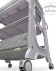Stork And Baby white plastic baby bath caddy with grey star-patterned storage shelves and lockable wheels