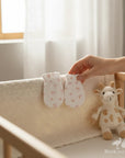 Stork And Baby white newborn mittens with pink paw print pattern, soft and cozy for baby.