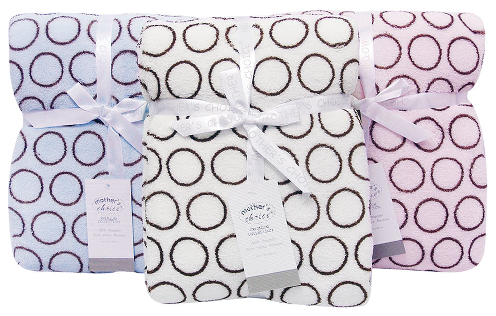 Three patterned blankets with ribbons on a white background