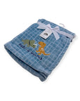 Blue baby blanket with dinosaur designs and a tag on a white background