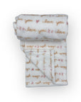 Folded baby blanket with 'I love you' text on a white background