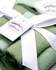 Green baby blankets with a white ribbon and 'mother's choice' tag.
