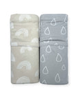 Two folded towels with rainbow and raindrop patterns on a white background