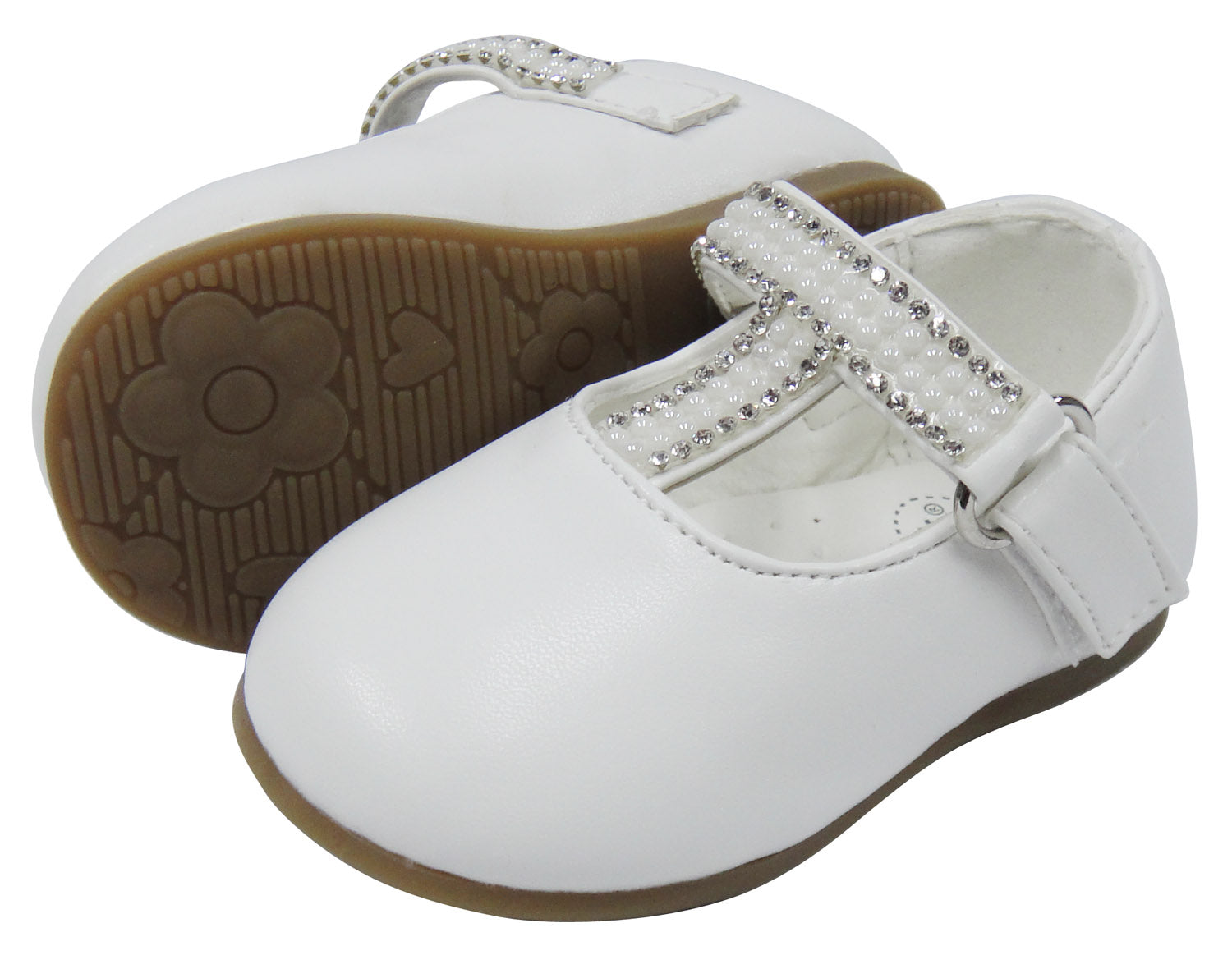 White children's shoes with a strap and brown sole on a white background
