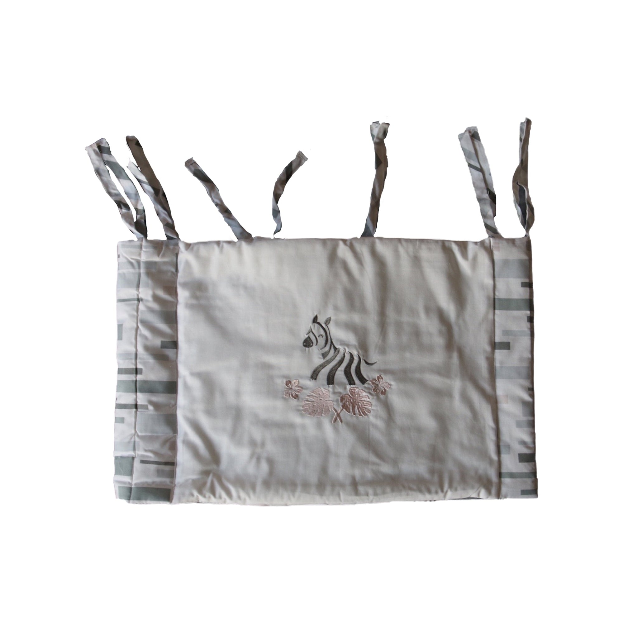 Crib bumper with zebra design on a white background