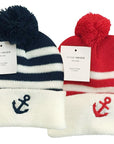 Two knit hats with pom-poms, one navy and white striped with an anchor, the other red and white with an anchor, on a white background.