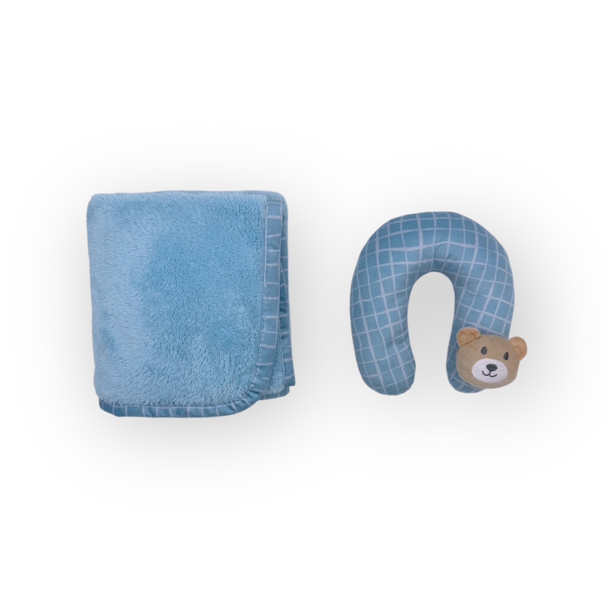Blue towel and blue neck pillow with teddy bear design on a white background