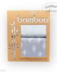 Packaging of bamboo waterproof change pad covers with a tree pattern on a white background.