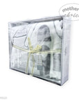 Packaged baby booties with a bow, branded 'Mother's Choice', on a white background.
