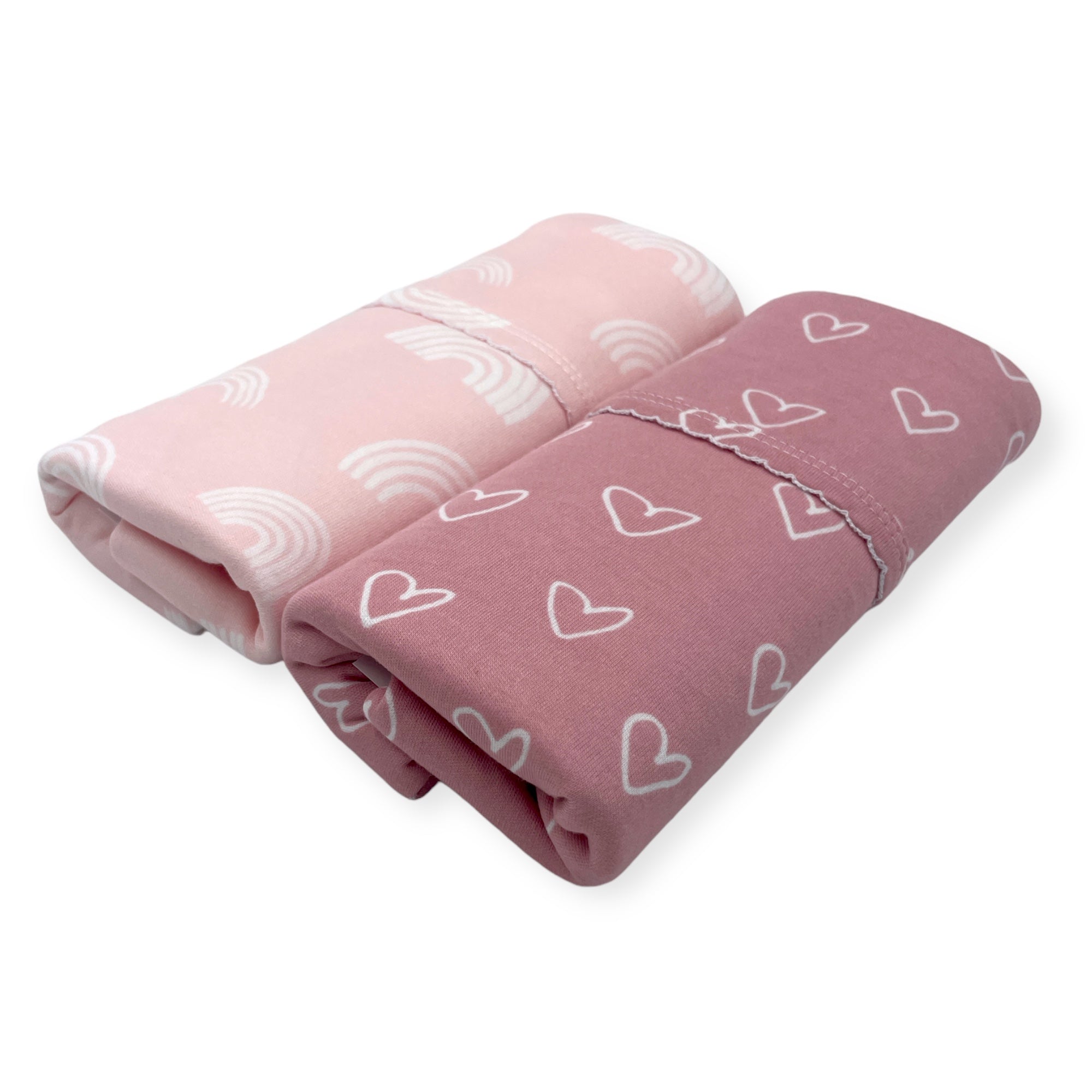 Two folded blankets with heart patterns on a white background