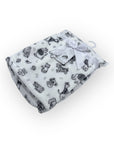 White blanket with black animal prints and a white tag on a white background