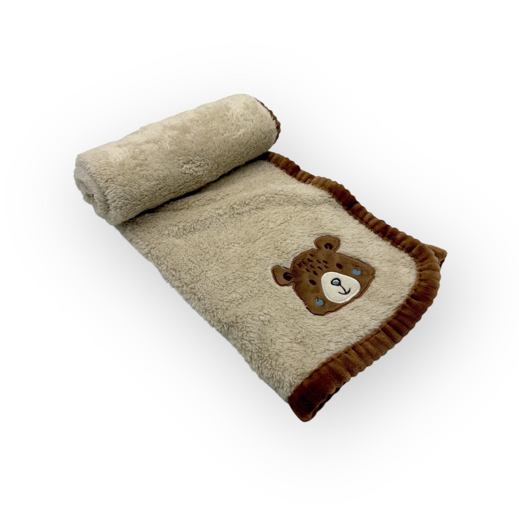 Folded blanket with a teddy bear design on a white background