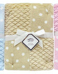 Three baby blankets in blue, beige, and pink with white polka dots, each labeled 'Baby's First'.
