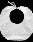 White baby bib with floral embroidery on a black background