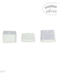 Set of three folded towels with a gray border and white center on a white background, featuring 'Mother's Choice' branding.