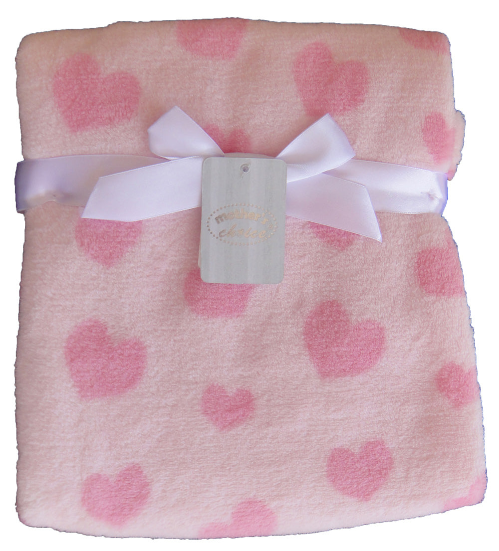 Folded pink blanket with heart patterns and a white bow, on a white background