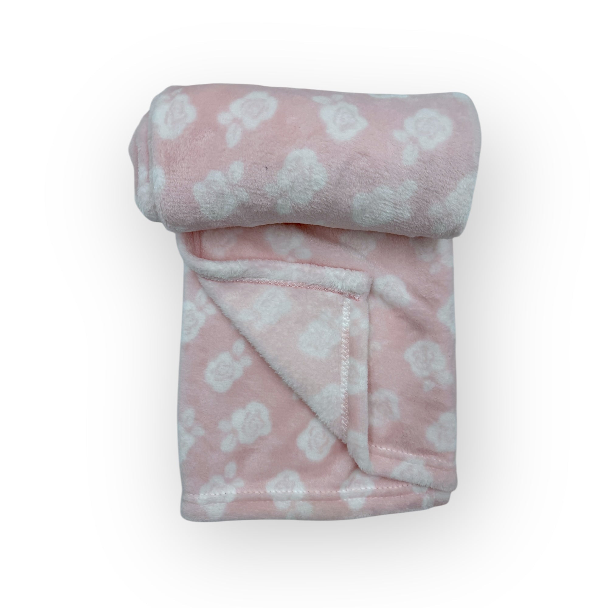 Folded pink blanket with white paw prints on a white background