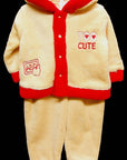 Children's fleece outfit with red trim and 'Too Cute' text on a black background