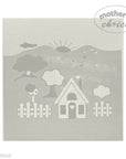 Decorative stencil with house, tree, and fence design on a light gray background.