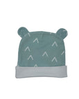 Green baby hat with white patterns on a white background