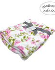 Floral blanket with a gray ribbon on a white background, branded 'Mother's Choice'.