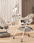 Two beige high chairs with trays on a wooden floor.