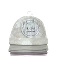 Gray floral-patterned baby cap on a white background with a label.